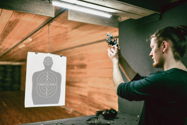 istock Male Checking Revolver Barrel At Gun Range 1313320078