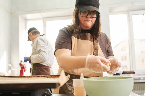 istock Serious baker sculpts and shapes cookies from the dough 1313320789
