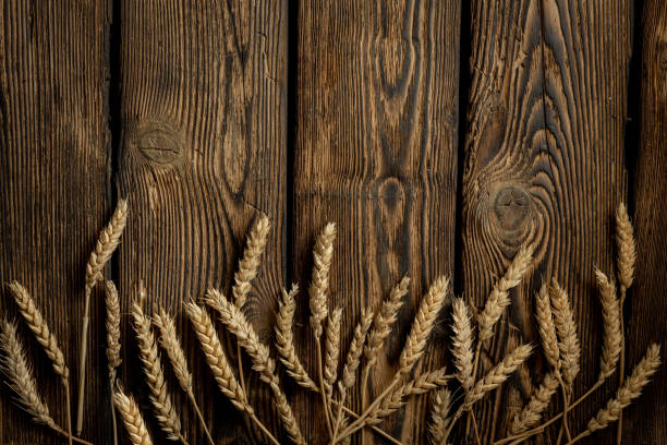 istock Wheat ears on the rustic wooden table background. 1313321097