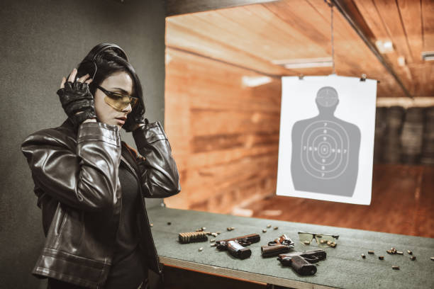 istock Focused Female Setting Up Ear Muffs On Gun Range 1313321122