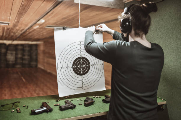 istock Male With Ear Muffs Setting Up Target For Gun Training On Range 1313321405