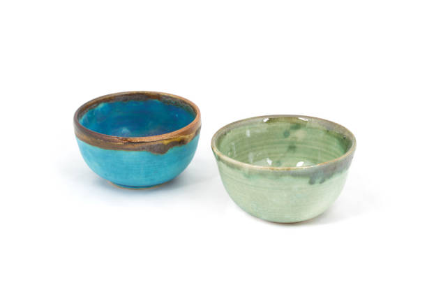 istock Blue and green hand made clay bowls isolated on white background 1313321609