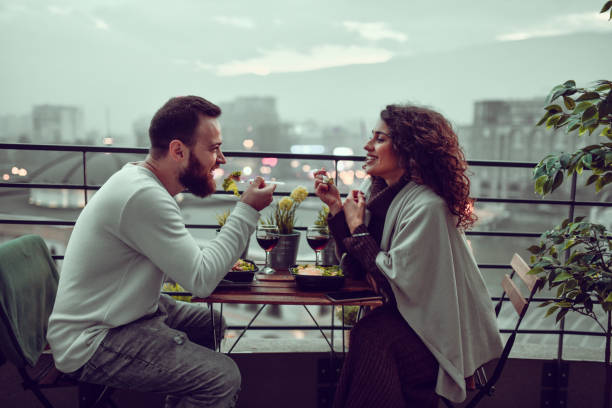 Loving Couple Enjoying Salad Dinner Date oving Couple Enjoying Salad Dinner Date caesar salad food salad tuna stock pictures, royalty-free photos & images