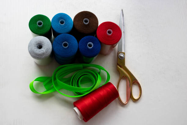 Close up sewing accessories on light background