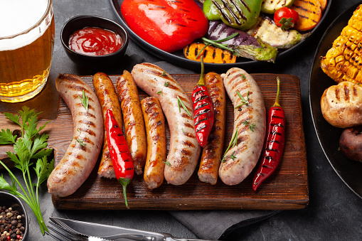 Grilled sausages and vegetables with spices and herbs