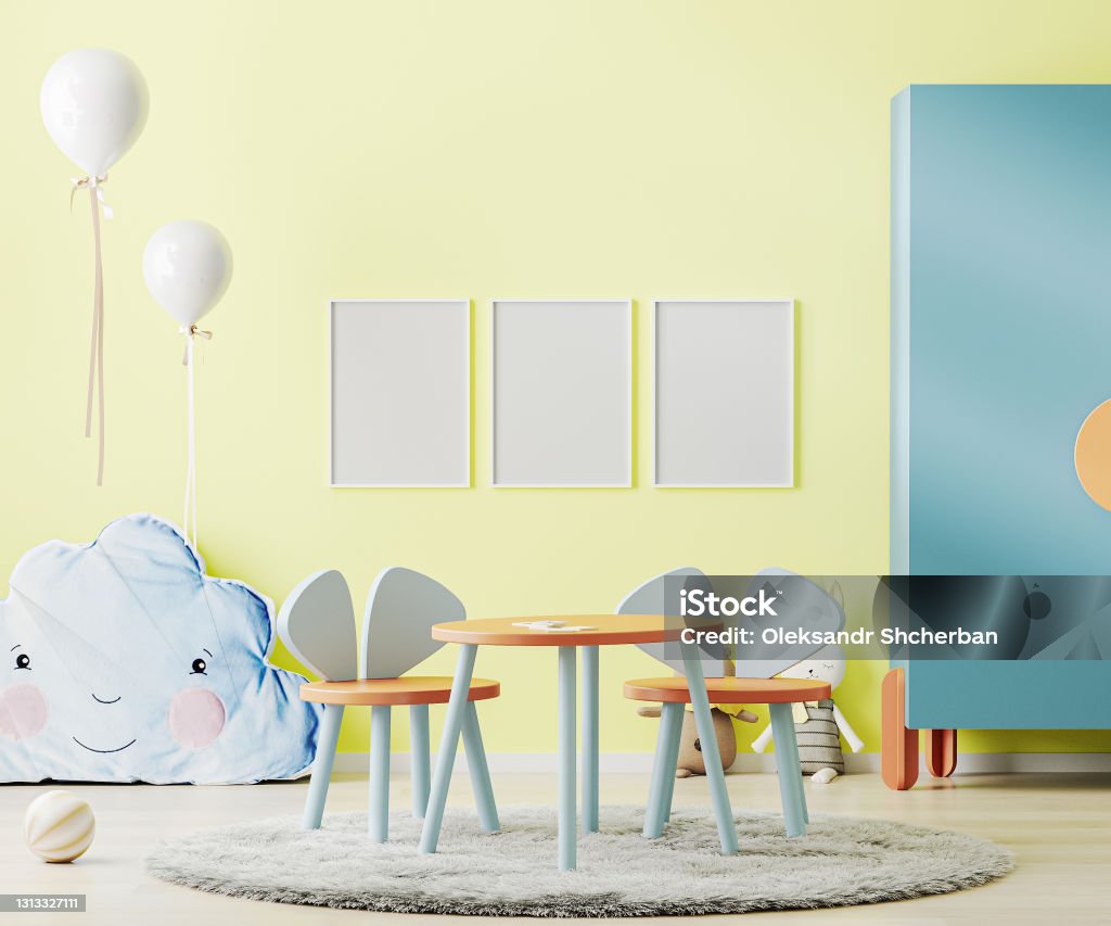 Poster frame mock up in bright yellow child room with table, toys and cupboard, kids room interior mockup, children playroom, 3d rendering Apartment Stock Photo