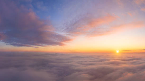 istock view from an airplane on a beautiful saturated sunrise above the clouds 1313328679