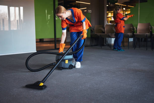 istock Janitor in rubber gloves getting ready for vacuuming the floor 1313329743