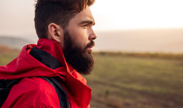 istock Serious bearded traveler standing in field 1313331079
