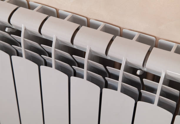 istock White painted radiator heater, classic water heating system. 1313331232