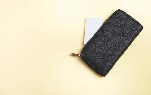 istock Womans wallet and card, on an isolated yellow background. 1313331281