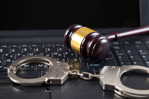 istock Judge gavel, police handcuffs and computer keyboard. 1313331286
