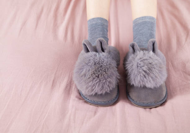 istock Soft comfortable home slippers. Gray color slippers and socks. 1313331325