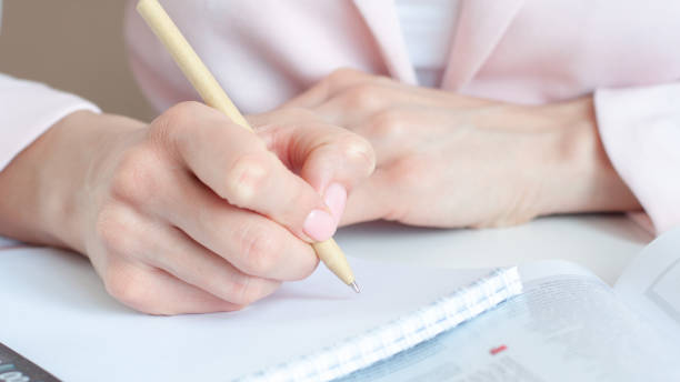 istock close up of woman hands with calculator counting and taking notes to notebook 1313331543