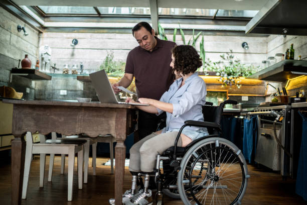 istock Couple doing finances at home - woman with disabilities 1313331788
