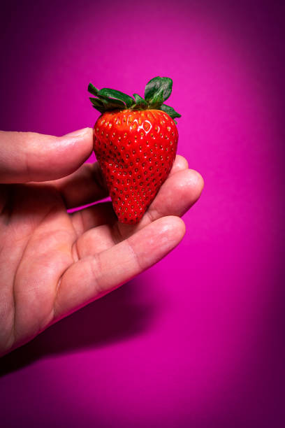 istock Hold red delicious strawberry in hand 1313332851