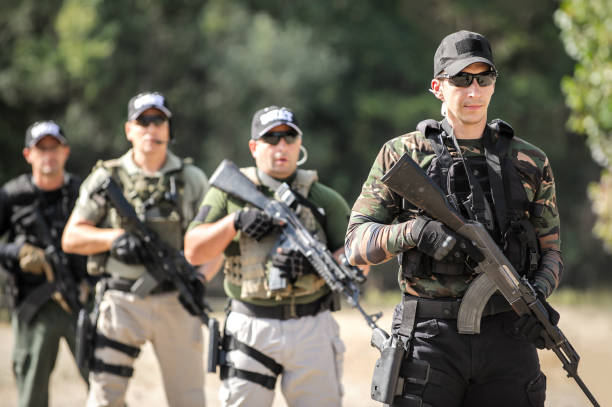 istock Army soldiers in action tactical combat shooting from machine gun 1313333448