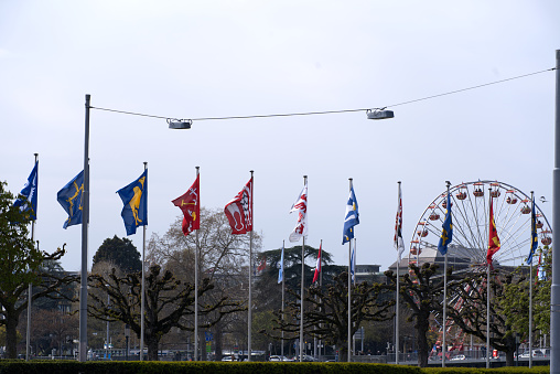 Guild flags at border of lake Zurich because of spring festival Sechseläuten. Photo taken April 19th, 2021, Zurich, Switzerland.