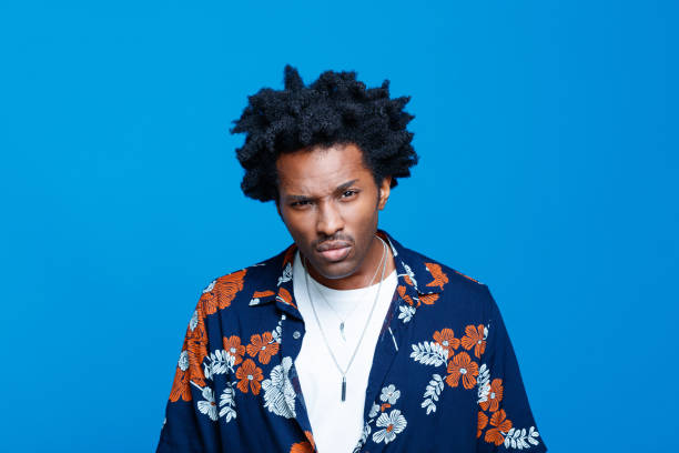 istock Angry man in hawaiian shirt against blue background 1313335687