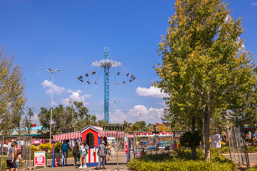 Amusement park at Irene Village Mall, with children enjoying the swings.