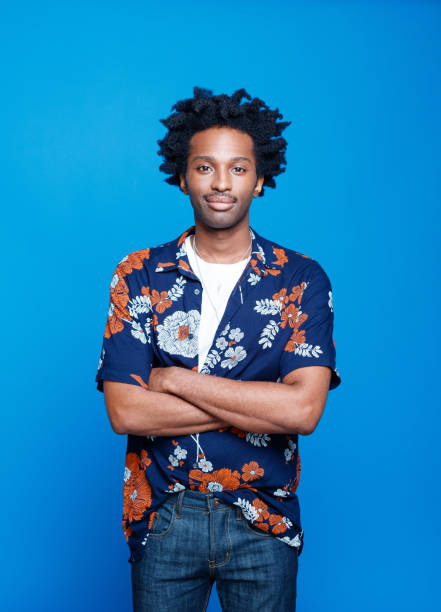 istock Friendly young man in hawaiian shirt on blue background 1313336901