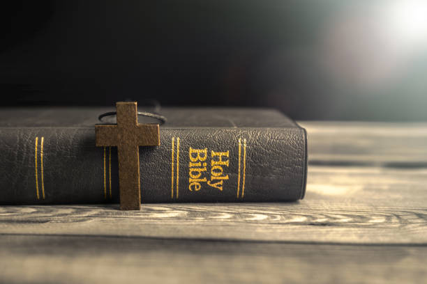 istock wooden cross with Holy Bible 1313337419