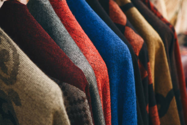 istock Close-up of a lot of sweaters and pullovers in a row 1313338399