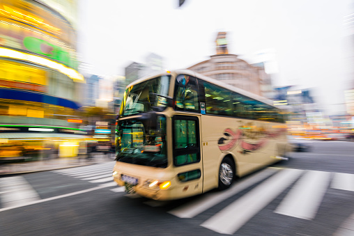 Tokyo, Japan - December 10, 2015: : Motion blurred bus at the heart of Ginza District in Tokyo. Wako Building is at the background.