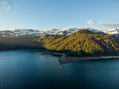 Aerial view of Conguillio lake and Sierra Nevada mountains at sunset in Conguillio National Park, La Araucania region, southern Chile