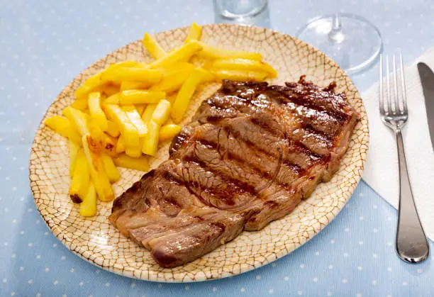 Tasty homemade grilled beef steak served with fried potato