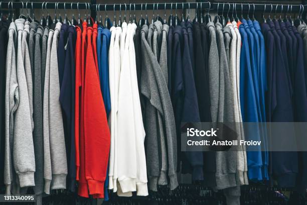 Many Sweatshirts Or Pullovers Hang On A Hanger In A Store Stock Photo - Download Image Now