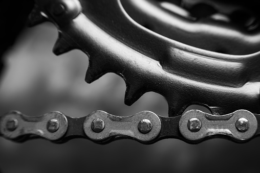 Bicycle details, details of the steering wheel of gears and chain, dark abstract background, selective focus.