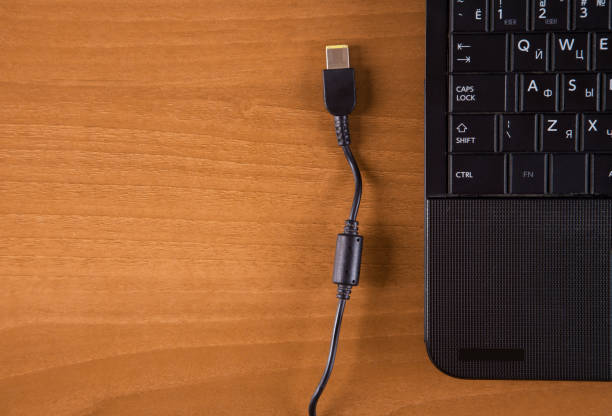 istock Wooden background isolated charger and computer. 1313344106