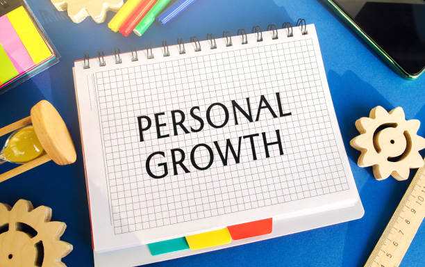 istock Notebook with inscription Personal growth. Self-improvement of skills, knowledge, personal qualities and life goals. Motivation and self-motivation concept. Gears, hourglass, telephone 1313346475