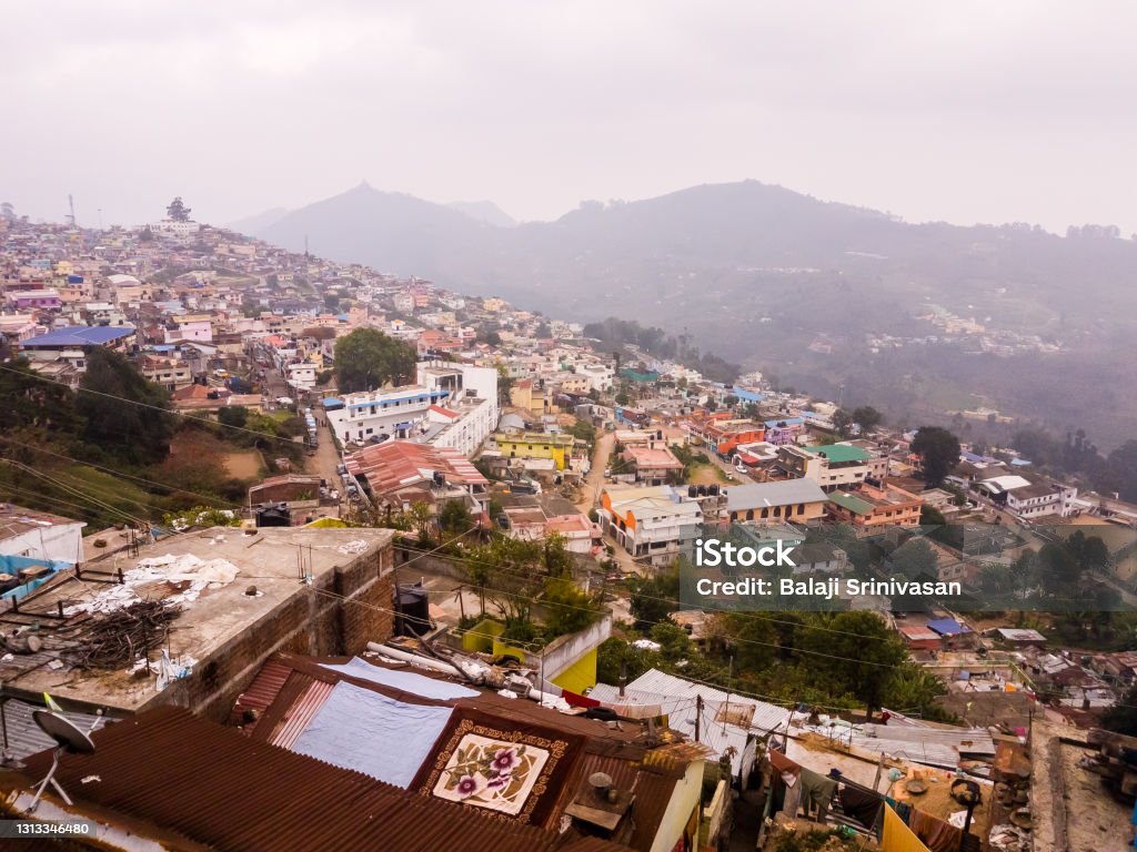 A townscape of the hill station of Kodaikanal A townscape of the hill station of Kodaikanal with buildings clustered on a hill side. Aerial View Stock Photo