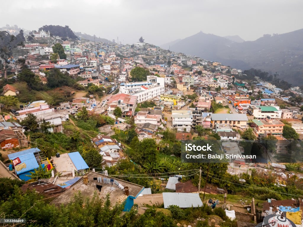 The hill station of Kodaikanal A townscape of the hill station of Kodaikanal with buildings clustered on a hill side. Aerial View Stock Photo