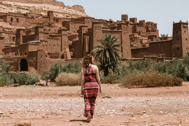 istock Girl walking towards Ouarzazate ruins 1313346866