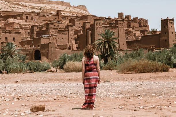 istock Girl walking towards Ouarzazate ruins 1313346877