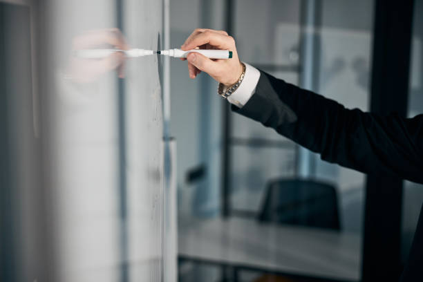istock Male entrepreneur hand writing on whiteboard in office 1313347200