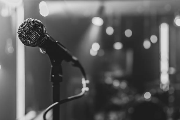 Close up microphone on blurred background with bokeh. Close up of a microphone on a concert stage with beautiful lighting. karaoke photos stock pictures, royalty-free photos & images