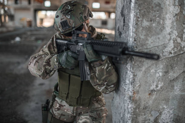 istock Armed woman soldier in war zone 1313348292