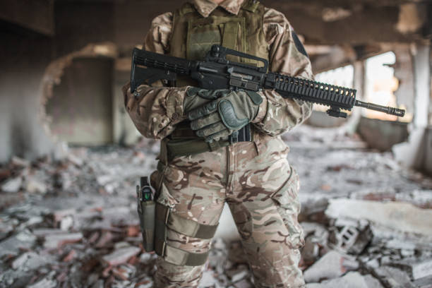 istock Female special forces soldier in camouflage uniform resting in war zone 1313349151