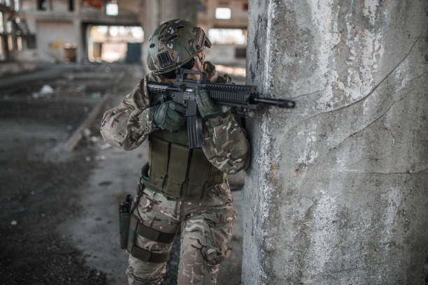istock Armed woman mercenary in war zone 1313349694