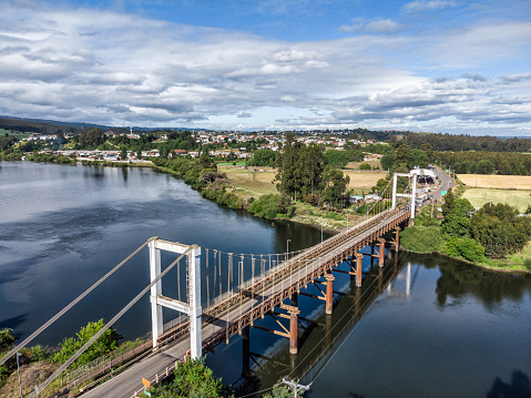 Aerial view of a suspension bridge over Imperial river in Carahue, La Araucania region, southern Chile