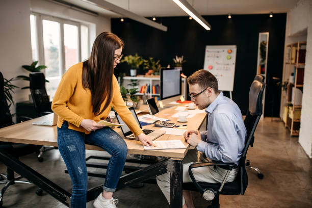 istock Business people working together in bright office, sitting at desk 1313351649
