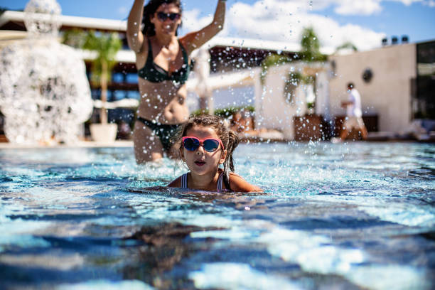 istock Mother, daughter and pool 1313352032