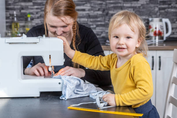 istock Young mother is sewing with her cute smiling liitle son together. 1313352794