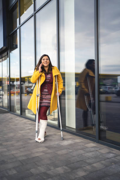 istock Woman with plaster foot talking on phone 1313352870
