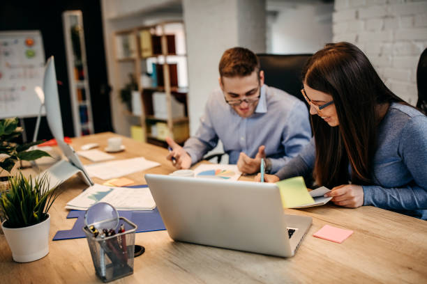 istock Two young businessman having a successful meeting in modern office. 1313352999