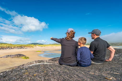 Family enjoys Derrynane beach on the Ring of Kerry, Ireland on a sunny day.